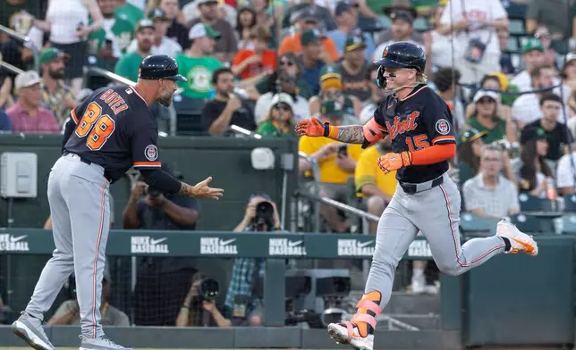 Detroit Tigers' Max Clark, right, greets third base coach Billy Boyer (88) after hitting a two-run home run during the sixth inning of a baseball game against the Athletics, Saturday, Aug. 1, 2026, in West Sacramento, Calif. (AP Photo/Sara Nevis)