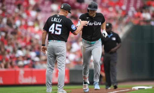 Miami Marlins' Jakob Marsee, right, celebrates with third base coach Blake Lalli (45) after a solo home run during the third inning of a baseball game against the Cincinnati Reds on Saturday, Aug. 15, 2026 in Cincinnati. (AP Photo/Tanner Pearson)