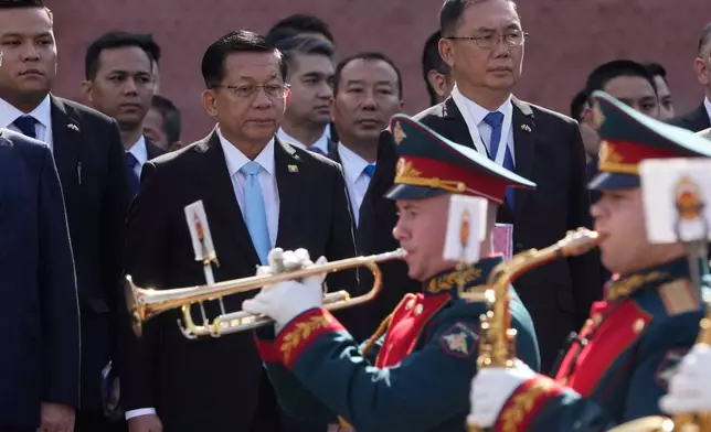 Myanmar President Min Aung Hlaing, center, attends a wreath-laying ceremony at the Tomb of the Unknown Soldier near the Kremlin wall in Moscow, Tuesday, Aug. 18, 2026. (AP Photo/Pavel Bednyakov, Pool)