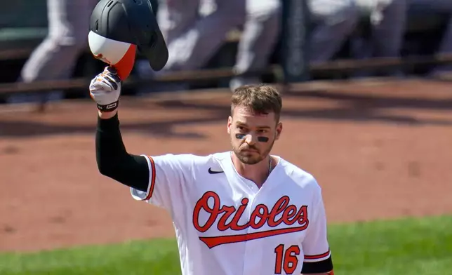 FILE - Baltimore Orioles' Trey Mancini tips his helmet as fans give him a standing ovation prior to a baseball game against the Boston Red Sox, April 8, 2021, on Opening Day in Baltimore. (AP Photo/Julio Cortez, File)