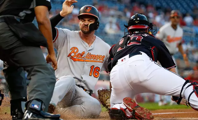 FILE - Baltimore Orioles' Trey Mancini (16) is safe at home before the tag by Washington Nationals catcher Yan Gomes during the first inning of a baseball game at Nationals Park, Aug. 27, 2019, in Washington. (AP Photo/Alex Brandon, File)
