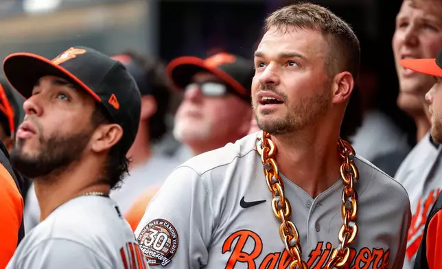 FILE - Baltimore Orioles' Trey Mancini celebrates with a chain around his neck after hitting a solo home run against the Minnesota Twins and watches another go out by Ryan Mountcastle in the sixth inning of a baseball game, July 3, 2022, in Minneapolis. (AP Photo/Bruce Kluckhohn, File)