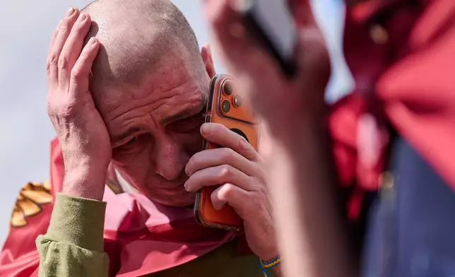 Ukrainian soldiers speak to their relatives after returning from captivity after a Prisoners of War (POWs) exchange between Russia and Ukraine, in Chernihiv region, Ukraine, Wednesday, Aug. 19, 2026. (AP Photo/Francisco Seco)