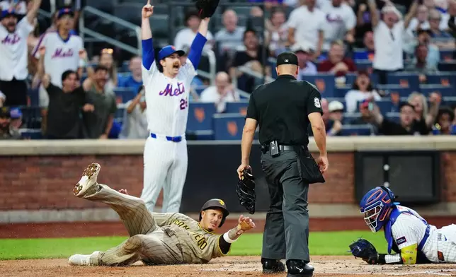 New York Mets pitcher Nolan McLean reacts after catcher Francisco Alvarez, right, tagged out San Diego Padres' Manny MacHado during the first inning of a baseball game Monday, Aug. 17, 2026, in New York. (AP Photo/Frank Franklin II)