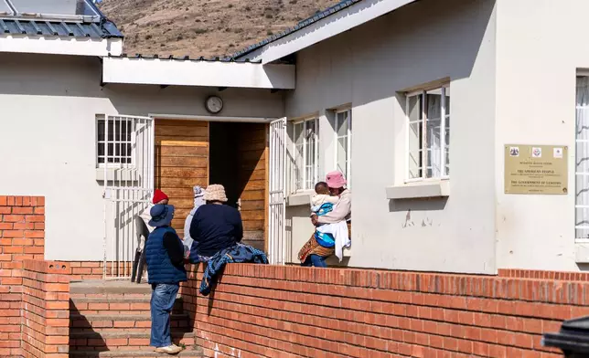 Patients wait outside Mpharane Health Centre in Mohale's Hoek district, Lesotho, Friday, July 10, 2026. (AP Photo/Kayleen Morgan)