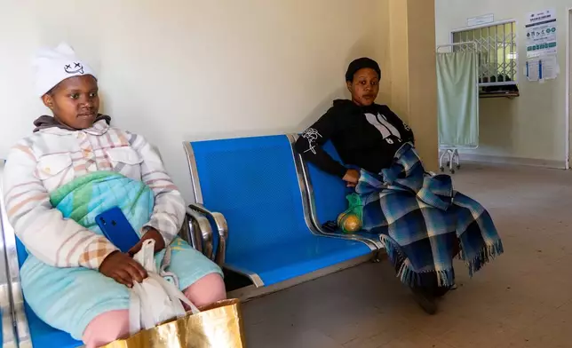 Expectant mothers Bonolo Tebelo, left, and Mpolokeng Mafereka wait for their appointments at Mpharane Health Centre in Mohale's Hoek district, Lesotho, Friday, July 10, 2026. (AP Photo/Kayleen Morgan)