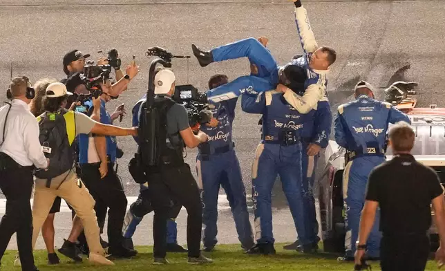 Ryan Preece, center, celebrates with his crew after winning the NASCAR auto race at Daytona International Speedway, Saturday, Aug. 29, 2026, in Daytona Beach, Fla. (AP Photo/John Raoux)