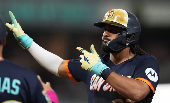 San Diego Padres' Fernando Tatis Jr. celebrates after hitting an RBI single during the fifth inning of a baseball game against the Minnesota Twins Friday, Aug. 21, 2026, in San Diego. (AP Photo/Gregory Bull)