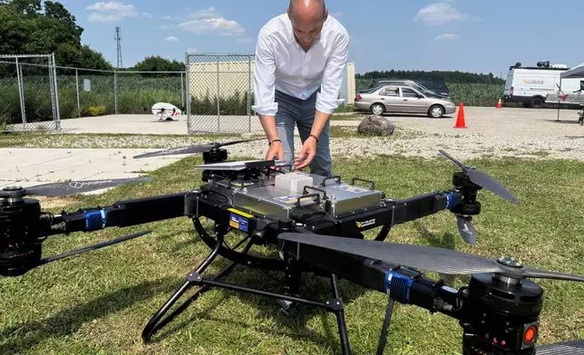 Volatus Aerospace COO Greg Colacitti inspects a heavy lift drone before a test run on July 13, 2026, in Kleinburg, Ontario. (AP Photo/Kelvin Chan)