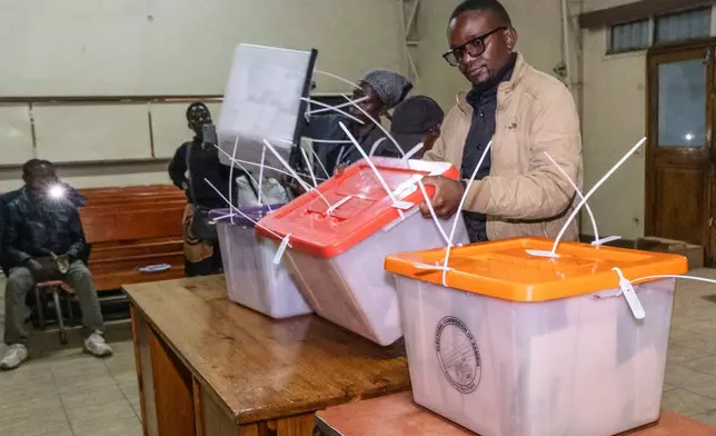 Election workers open containers of ballots as counting begins in Lusaka, Zambia, Thursday, Aug. 13, 2026. (AP Photo/Anita Reed)