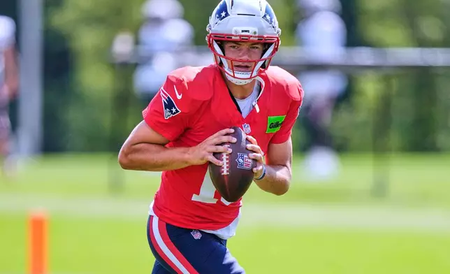 New England Patriots quarterback Drake Maye looks to pass during the team's NFL football training camp, Friday, July 31, 2026, in Foxborough, Mass. (AP Photo/Charles Krupa)