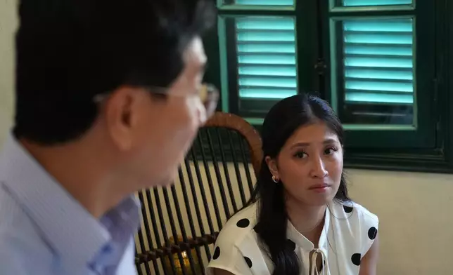 Nguyen Thi Quynh Tam looks at her father after an interview with The Associated Press in Hanoi, Vietnam, Thursday, Aug. 13, 2026. (AP Photo)