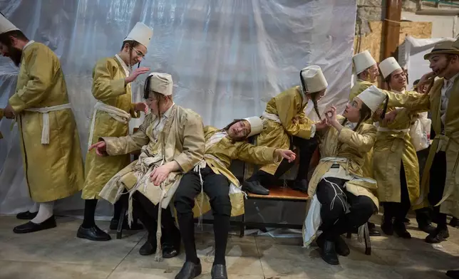 Ultra-Orthodox Jewish men celebrate the festival of Purim in Jerusalem, Wednesday, March 4, 2026. (AP Photo/Ohad Zwigenberg)