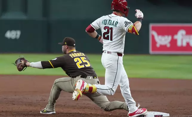 San Diego Padres first baseman Ty France (25) makes a catch at first base for an out against Arizona Diamondbacks' Lars Nootbaar (21) during the second inning of a baseball game, Tuesday, Aug. 4, 2026, in Phoenix. (AP Photo/Ross D. Franklin)