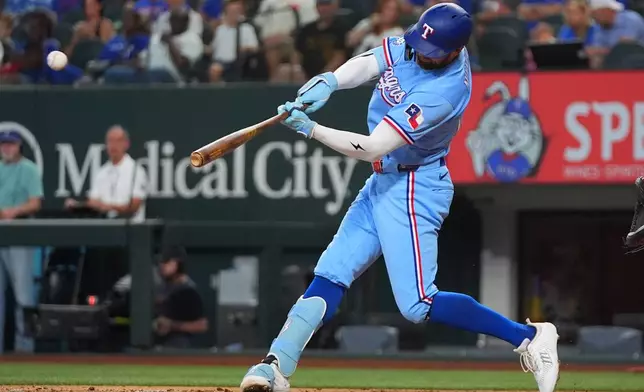 Texas Rangers' Brandon Nimmo hits a three-run home run during the third inning of a baseball game against the Baltimore Orioles, Sunday, Aug. 9, 2026, in Arlington, Texas. (AP Photo/LM Otero)