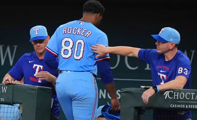 Texas Rangers starting pitcher Kumar Rocker (80) heads to the dugout after a pitching change during the fourth inning of a baseball game against the Baltimore Orioles, Sunday, Aug. 9, 2026, in Arlington, Texas. (AP Photo/LM Otero)