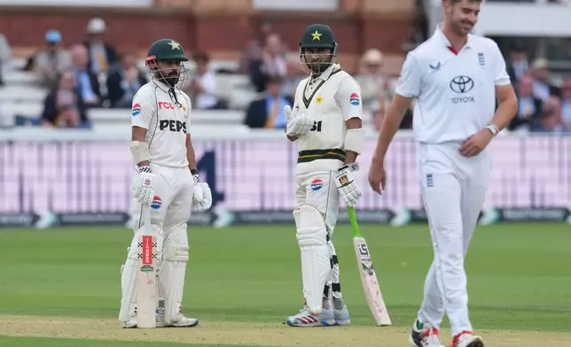 Pakistan's Saud Shakeel, left, reacts after hitting a six on a delivery by England's Josh Tongue, right, on day four of the second cricket test match between England and Pakistan in London, Sunday, Aug. 30, 2026. (AP Photo/Dave Shopland)