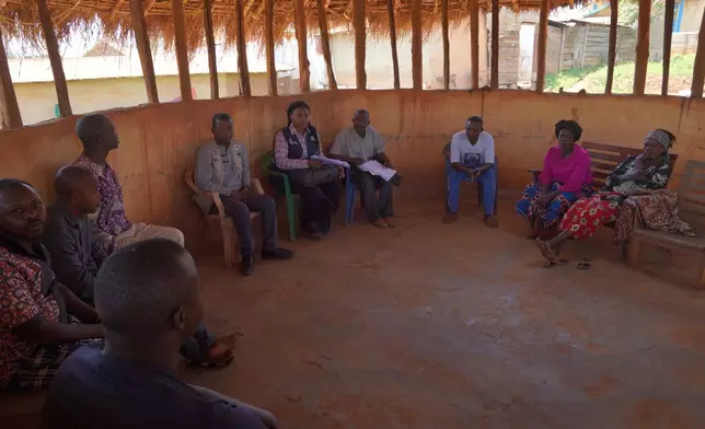 Ana Ndroy Kasime, a community health worker ,second from left, meets other health workers during an Ebola contact tracing in Nizi, Ituri province, eastern Congo, Friday, Aug. 14, 2026. (AP Photo/Dieudonne Dirole)