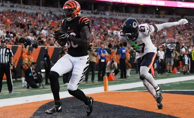 Cincinnati Bengals wide receiver Colbie Young scores a touchdown in front of Chicago Bears defensive back Dontae Manning (27) during the first half preseason NFL football game Saturday, Aug. 22, 2026, in Cincinnati. (AP Photo/Tanner Pearson)