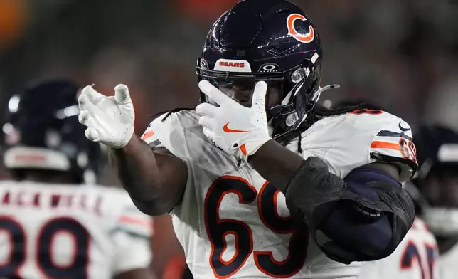 Chicago Bears defensive lineman Jeremiah Martin (69) celebrates after stopping Cincinnati Bengals wide receiver Kendric Pryor during the second half of a preseason NFL football game Saturday, Aug. 22, 2026, in Cincinnati. (AP Photo/Joshua A. Bickel)