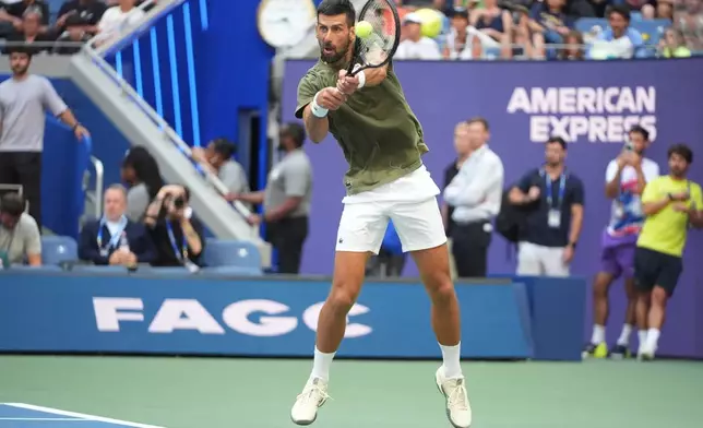 Novak Djokovic, of Serbia, returns the ball to Alexander Zverev, of Germany, during a practice at the U.S. Open tennis championships Wednesday, Aug. 26, 2026, in New York. (AP Photo/Frank Franklin II)