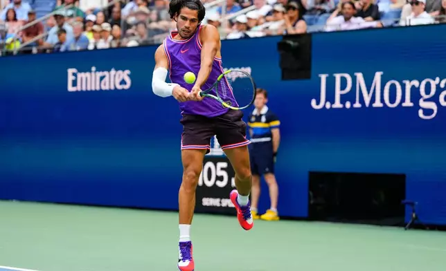 Carlos Alcaraz, of Spain, returns the ball during a mixed doubles match at the U.S. Open tennis championships, Tuesday, Aug. 25, 2026, in New York. (AP Photo/Yuki Iwamura)