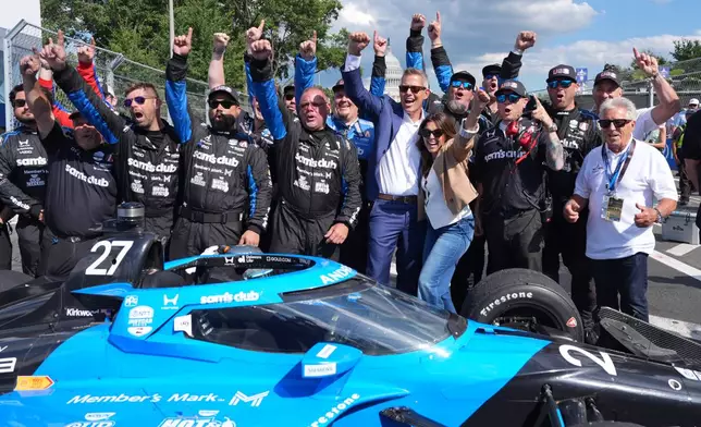 Transportation Secretary Sean Duffy joins for a photo after Kyle Kirkwood (27) won the IndyCar Freedom 250 Grand Prix auto race in Washington, Sunday, Aug. 23, 2026. (AP Photo/Alex Brandon)