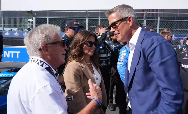 Transportation Secretary Sean Duffy talks with Mario Andretti after Kyle Kirkwood (27) won the IndyCar Freedom 250 Grand Prix auto race in Washington, Sunday, Aug. 23, 2026. (AP Photo/Alex Brandon)