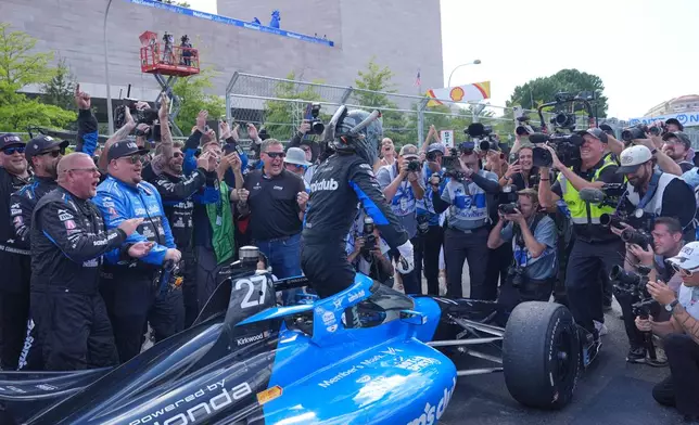 Kyle Kirkwood (27) celebrates with his team after winning the IndyCar Freedom 250 Grand Prix auto race in Washington, Sunday, Aug. 23, 2026. (AP Photo/Alex Brandon)