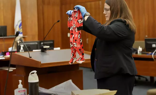 Assistant District Attorney Jennifer Sprague holds up as evidence the pajamas of Callan Clancy during the Lindsay Clancy murder trial at Plymouth Superior Court in Plymouth, Mass., on Wednesday, July 29, 2026. (David L. Ryan/The Boston Globe via AP, Pool)