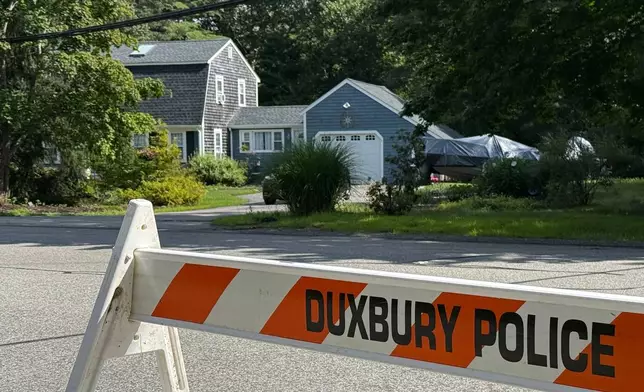 A police barricade stands outside the former home of Lindsay Clancy in Duxbury, Mass., on Friday, July 31, 2026. (AP Photo/Rodrique Ngowi)