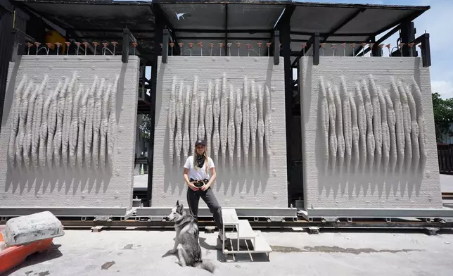 Anya Freeman, CEO and co-founder of KIND Designs, poses for a photograph with 3D-printed living seawalls Tuesday, May 12, 2026, in Miami. (AP Photo/Lynne Sladky)