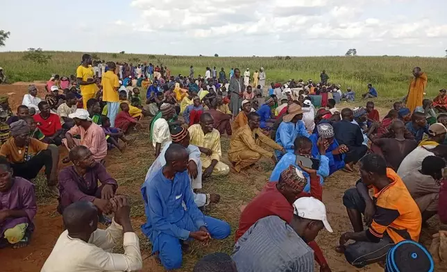 People attend a funeral for those who died when a boat capsized, in Sokoto, northwestern Nigeria, Thursday, Aug. 20, 2026. (AP Photo/Usman Yusuf)