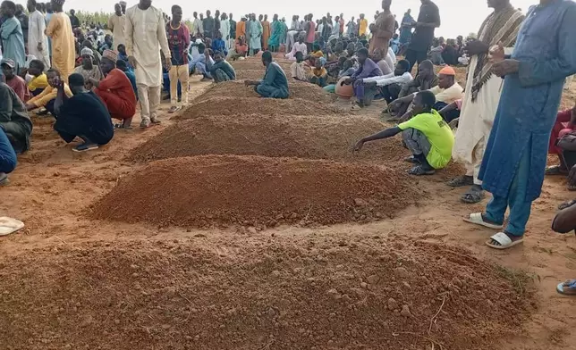 People attend a funeral for those who died after a boat capsized in Sokoto, northwestern Nigeria, Thursday, Aug. 20, 2026. (AP Photo/Usman Yusuf)