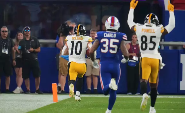 Pittsburgh Steelers wide receiver Kaden Wetjen (10) returns a punt for a touchdown as Buffalo Bills' Jimmy Ciarlo (35) and Cornell Powell (85) look on in the second half of a preseason NFL football game in Orchard Park, NY., Thursday, Aug. 27, 2026. (AP Photo/Gene J. Puskar)
