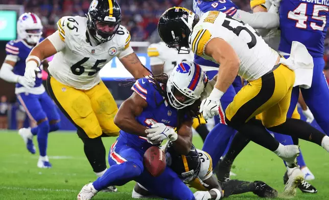 Buffalo Bills running back Ian Wheeler (27) recovers his own fumble as Pittsburgh Steelers defensive tackle Kyler Baugh (65) and Cole Holcomb (55) move in to make the stop in the second half of a preseason NFL football game in Orchard Park, NY., Thursday, Aug. 27, 2026. (AP Photo/Jeffrey T. Barnes)