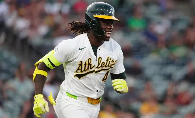 Athletics' Lawrence Butler reacts as he runs to first base after hitting a single in the fourth inning during a baseball game against the Minnesota Twins Tuesday, Aug. 25, 2026, in West Sacramento, Calif. (AP Photo/Alan Greth)