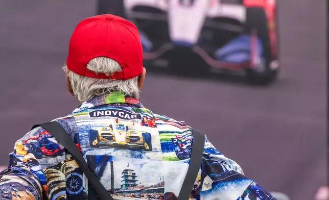 A spectator watches a practice round from the fan zone ahead of the Freedom 250 Grand Prix auto race in Washington, Saturday, Aug. 22, 2026. (AP Photo/Allison Robbert)