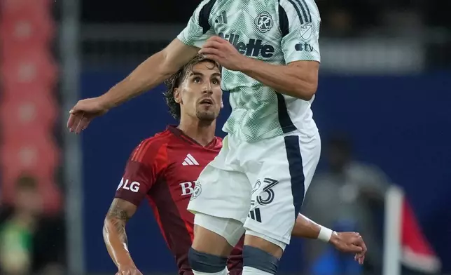 Toronto FC offense Theo Corbeanu (7) and New England Revolution defense Will Sands (23) vie for the header during the second half of a MLS soccer game in Toronto, Saturday, Aug. 15, 2026. (Nathan Denette/The Canadian Press via AP)