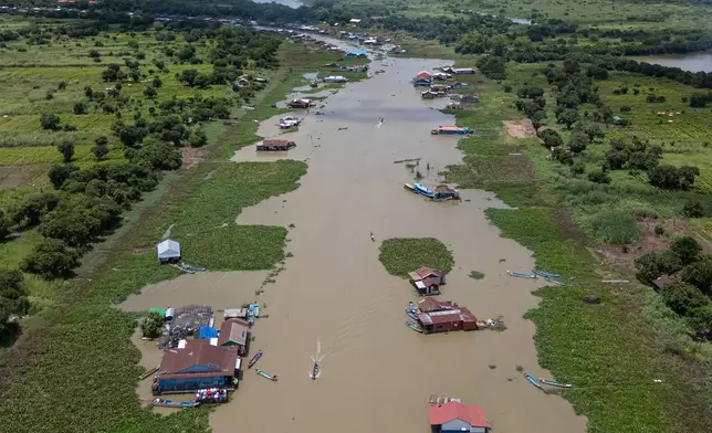 Boats traverse a floating village on Cambodia's Tonle Sap Lake on Monday, June 29, 2026. (AP Photo/Anton L. Delgado)