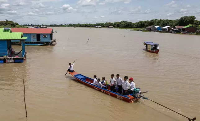 Students from a floating village on Cambodia's Tonle Sap Lake return to their homes in a school boat on Monday, June 29, 2026. (AP Photo/Anton L. Delgado)