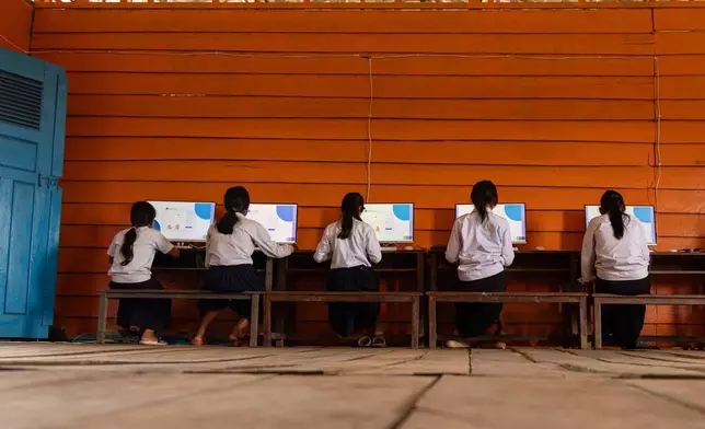 Students attend a computer class at a school in one of the floating villages of Cambodia's Tonle Sap Lake on Monday, June 29, 2026. (AP Photo/Anton L. Delgado)