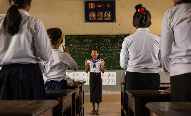 Students participate in a counting exercise at a school in one of the floating villages of Cambodia's Tonle Sap Lake on Monday, June 29, 2026. (AP Photo/Anton L. Delgado)