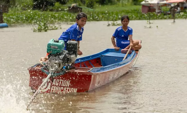 Students from a floating village on Cambodia's Tonle Sap Lake take a school boat back to their homes on Tuesday, June 30, 2026. (AP Photo/Anton L. Delgado)