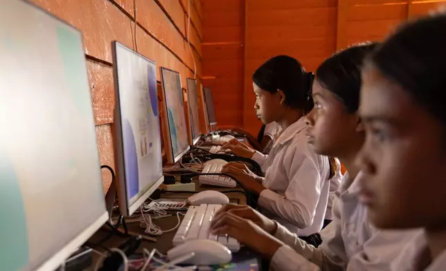 Students attend a computer class at a school in one of the floating villages of Cambodia's Tonle Sap Lake on Monday, June 29, 2026. (AP Photo/Anton L. Delgado)