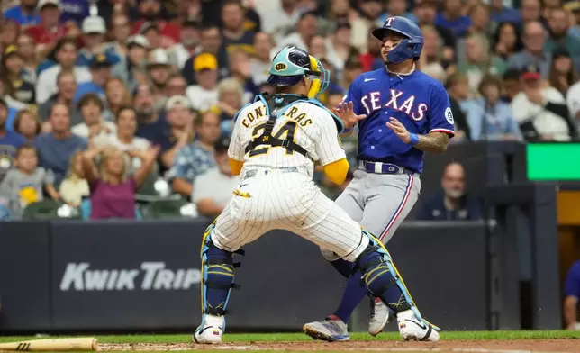 Milwaukee Brewers' William Contreras (24) tags out Texas Rangers' Cody Freeman at home during the third inning of a baseball game Saturday, Aug. 29, 2026, in Milwaukee. (AP Photo/Aaron Gash)