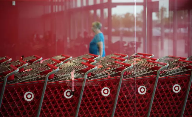 A shopper enters a Target store, Thursday, Aug. 13, 2026, in Woodbury, Minn. (AP Photo/Ellen Schmidt)