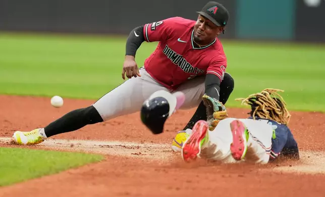 Cleveland Guardians' José Ramírez, right, steals second base on Arizona Diamondbacks shortstop Geraldo Perdomo, left, in the first inning of a baseball game in Cleveland, Friday, July 31, 2026. (AP Photo/Sue Ogrocki)