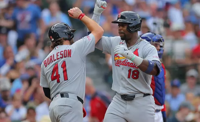 St. Louis Cardinals' Jordan Walker (18) celebrates with teammate Alec Burleson (41) after hitting a two-run home run during the fourth inning of a baseball game against the Chicago Cubs, Sunday, Aug. 16, 2026, in Chicago. (AP Photo/Melissa Tamez)