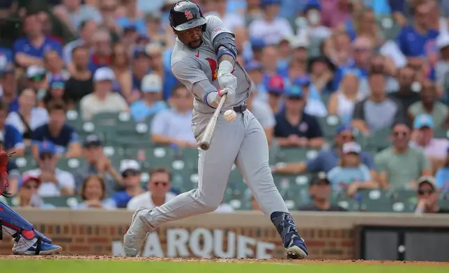 St. Louis Cardinals' Jordan Walker hits a two-run home run during the fourth inning of a baseball game against the Chicago Cubs, Sunday, Aug. 16, 2026, in Chicago. (AP Photo/Melissa Tamez)